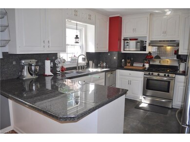 Kitchen with granite tile countertops.  Stainless 
