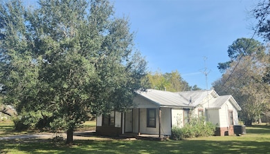 Metal roof with an oak tree in the front yard for