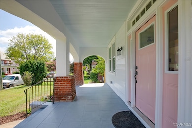 Porch featuring a lawn
