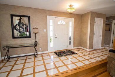 Custom tile/hardwood inlaid foyer.