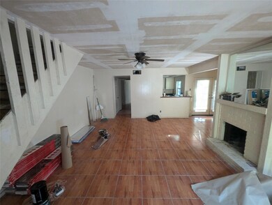 Unfurnished living room featuring ceiling fan and 