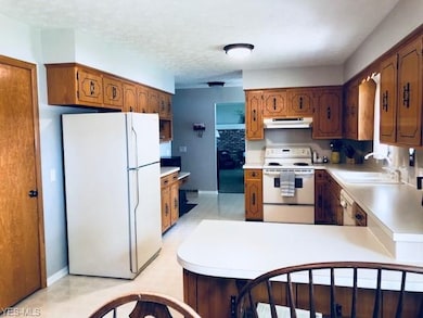 Another view of kitchen, showing family room