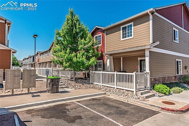 View of front facade featuring uncovered parking and stone siding