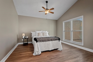 The room has two windows offering natural light and a view of the patio.