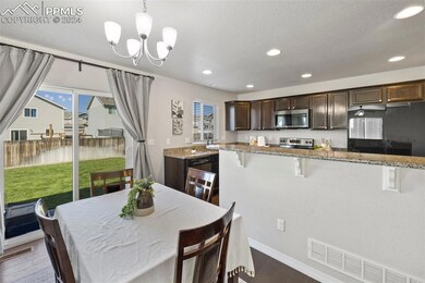 Dining area with walkout to backyard with new grass!