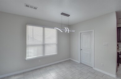 Unfurnished dining area featuring light tile patte