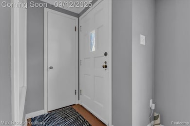 Entryway with baseboards and light tile patterned flooring