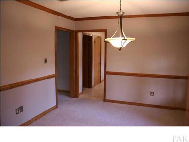 Formal dining room has chair rail, updated lighting and new updated paint with neutral palette.