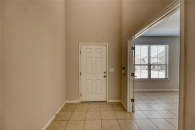 Foyer entrance featuring light tile patterned flo