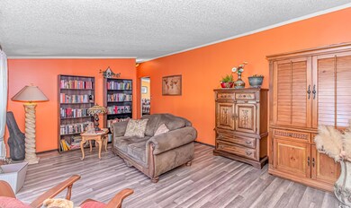 Sitting room featuring ornamental molding, light h