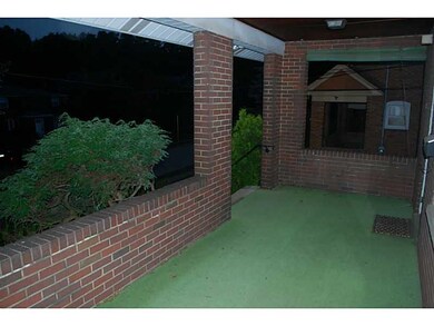 Exterior Front. Large porch overlooking quiet stre