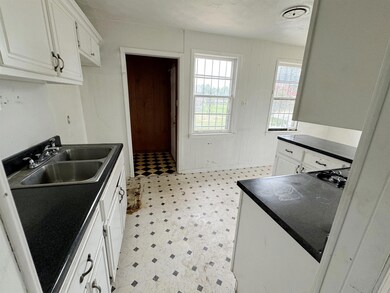 Kitchen featuring white cabinets, a textured ceili