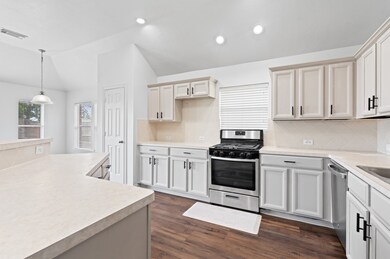 Different angle view of the kitchen facing towards the breakfast area of the home.