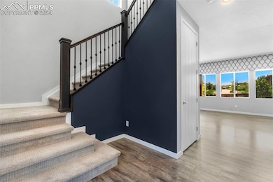 Staircase with hardwood / wood-style floors