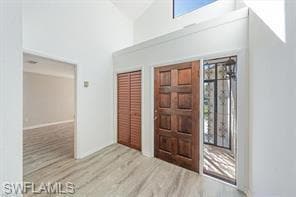 Foyer entrance with high vaulted ceiling and hardw