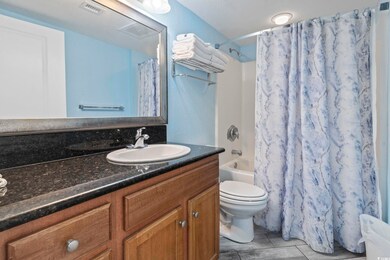 Full bathroom with vanity, toilet, tile patterned 