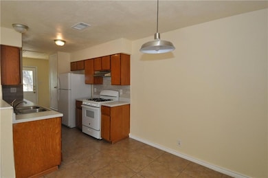 Kitchen with white appliances, under cabinet rang