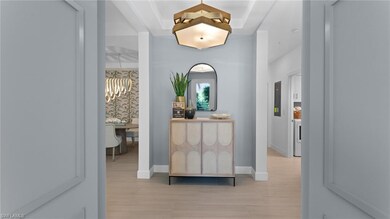 Corridor with light wood-style floors and baseboar