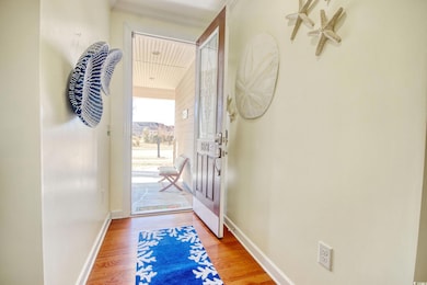 Entryway with baseboards and light wood-style floo