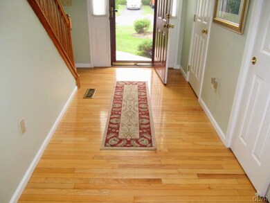 Hardwood floors extend to the large coat closet an