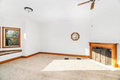 Unfurnished living room with ceiling fan and light