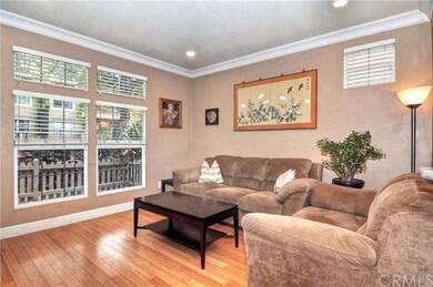 The lovely living room boasts bamboo flooring, upg