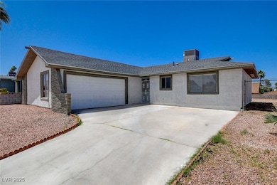 Ranch-style house with a garage, stucco siding, co
