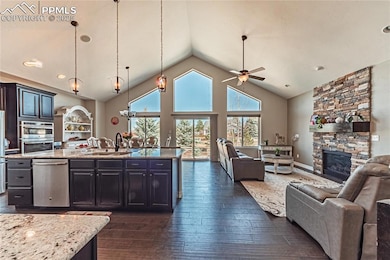 Kitchen with dark wood-type flooring, ceiling fan,