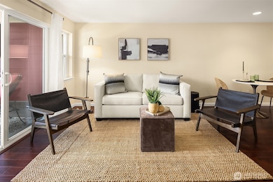 Light and bright living room with sliders to deck. With doors open it feels like you are bringing the outdoors in. Open floor plan for living room, kitchen and dining.