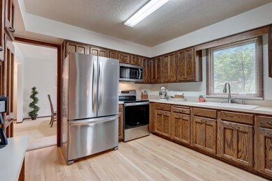 The well-appointed kitchen boasts new appliances, an abundance of storage options, and rich hardwood floors.