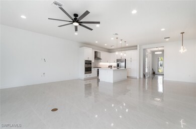 Unfurnished living room featuring light tile patte