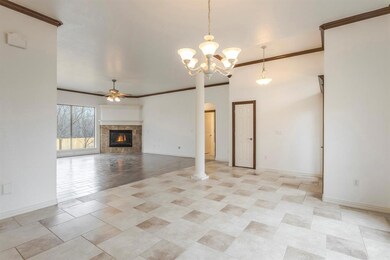 Unfurnished living room featuring chandelier, orna