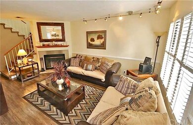 The living room features a toasty fireplace, lamin
