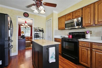 Kitchen has ample cabinet space + pantry & island.