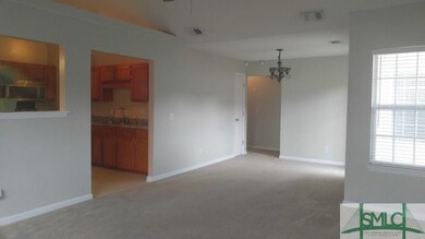 Family room open to dining area with access door t