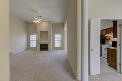 Unfurnished living room featuring light carpet, a 