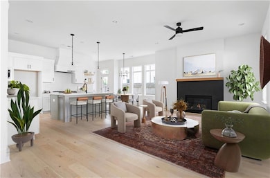 Living room with a glass covered fireplace, a ceil