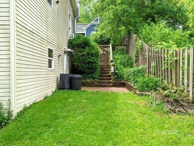 Side of house, steps to Upper apartment