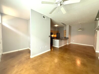 Unfurnished living room featuring baseboards, fin