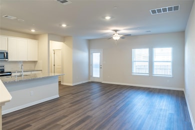 Kitchen with visible vents, a sink, appliances wi