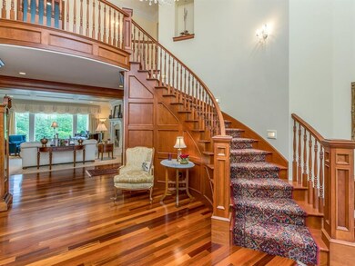 Brazilian cherry flooring and sweeping stairway we