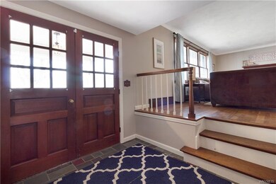 Double door entry to the large foyer adds to the o
