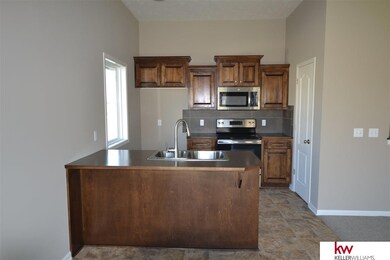 Stunning kitchen, rich stained birch cabinets, Stainless appliances, pantry and breakfast bar.