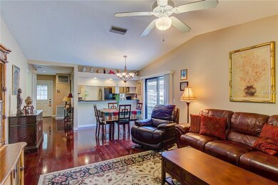 High Ceiling Living room looking to Front Door, Kitchen Counter, and Slider to side yard