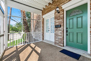 Inviting screened-in porch with a stylish green fr