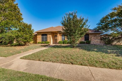 Single story home featuring brick siding and a fro