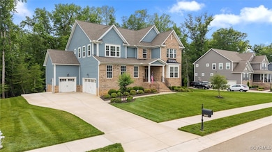 View of front of home with a garage, brick siding,