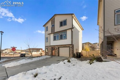 View of snow covered exterior featuring a garage