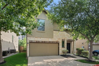 View of front of property with stone siding, conc