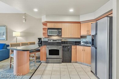 Kitchen with a sink, dark countertops, a peninsula